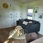 Cosy lounge seating area inside the Archwood 4 person shepherd’s hut