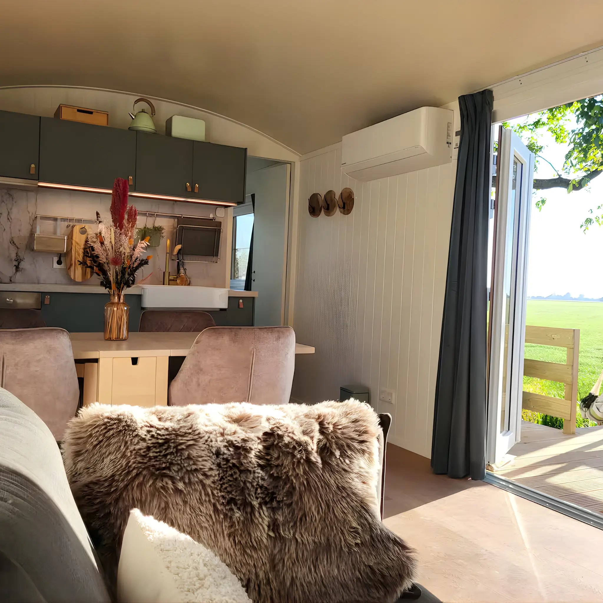 Open plan living and dining area with kitchen inside the Archwood 4 person shepherd’s hut
