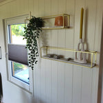 Interior wall shelf and window detail inside the shepherd’s hut