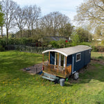 Elevated exterior view of a luxury shepherd’s hut for glamping accommodation