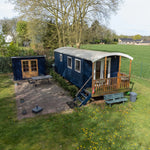 Luxury 2 person shepherd’s hut with private decking and outdoor seating in a countryside setting