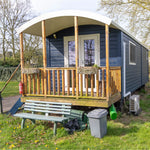 Front exterior view of a luxury shepherd’s hut with countryside views