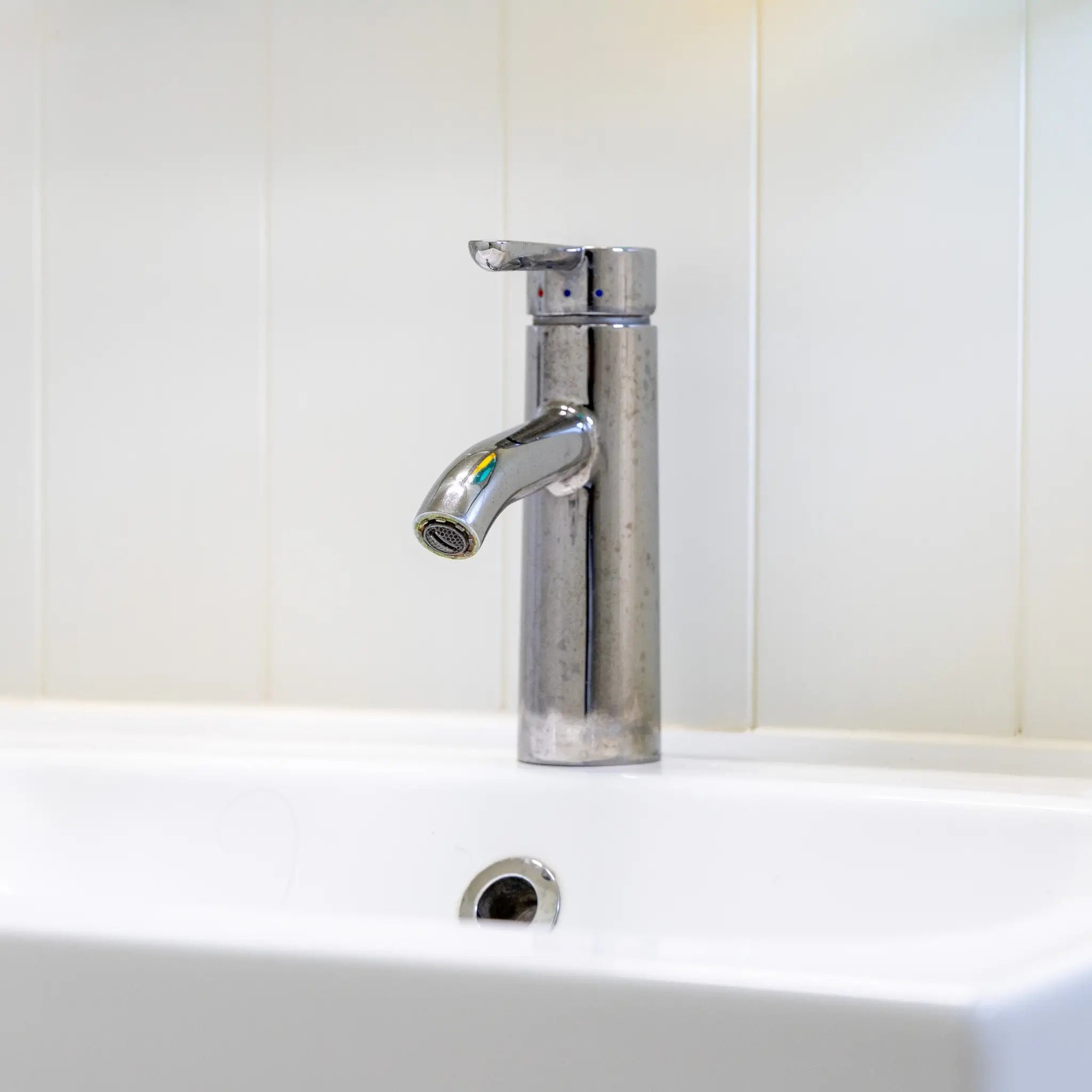 Modern bathroom sink and chrome tap inside a luxury 2 person shepherd’s hut