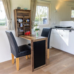 Dining area and kitchenette inside a luxury shepherd’s hut accommodation