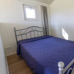 Comfortable double bed inside a cosy 2 person shepherd’s hut bedroom