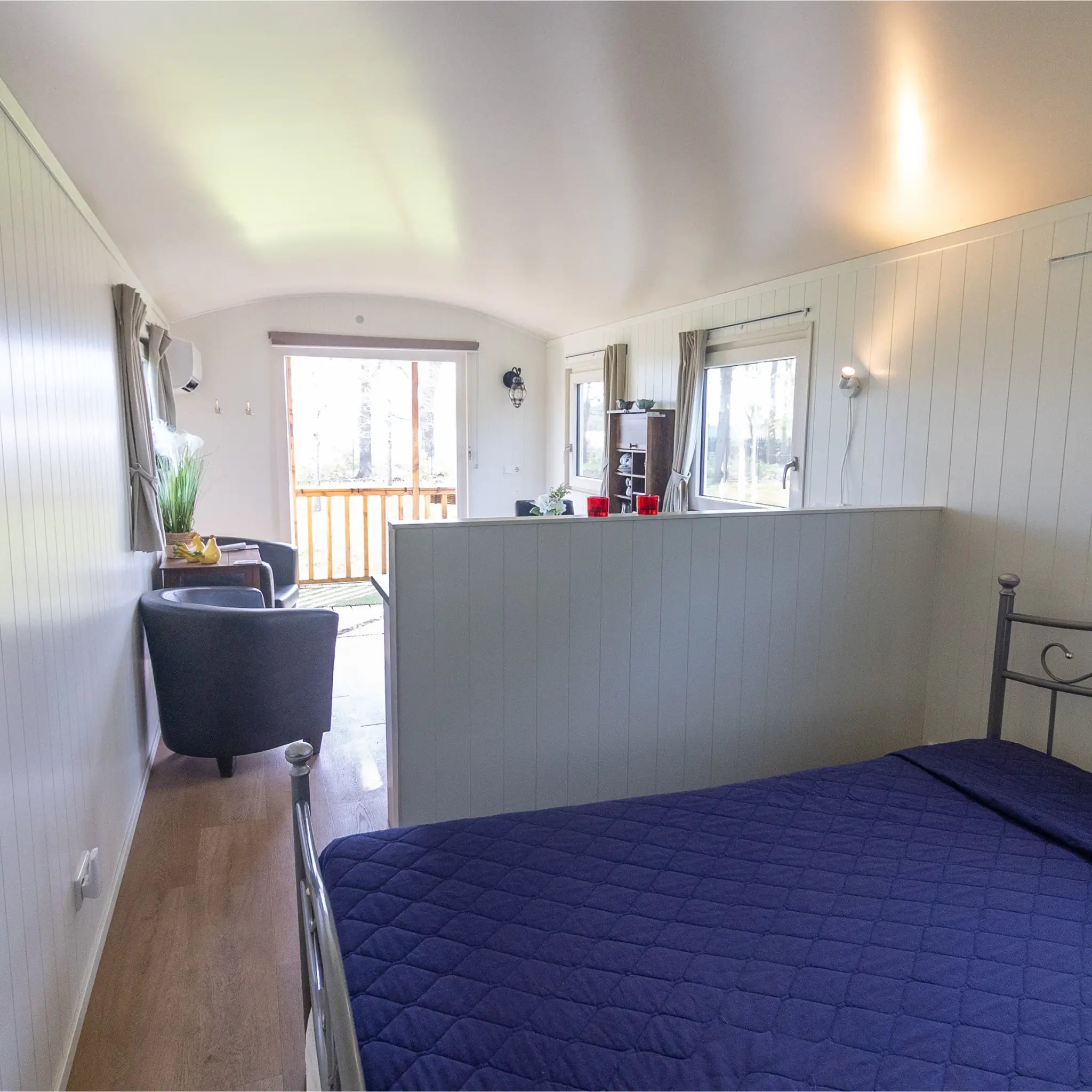 Open-plan bedroom and living space inside a luxury 2 person shepherd’s hut
