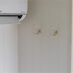 Interior wall hooks and climate control unit inside a contemporary shepherd’s hut