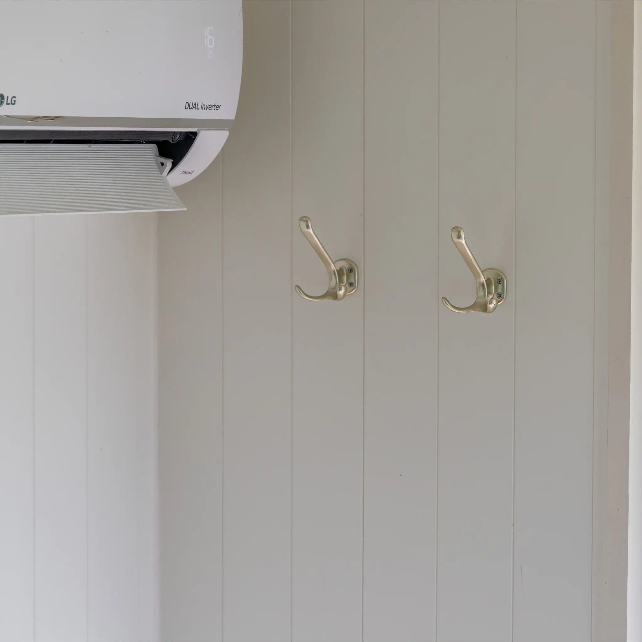 Interior wall hooks and climate control unit inside a contemporary shepherd’s hut