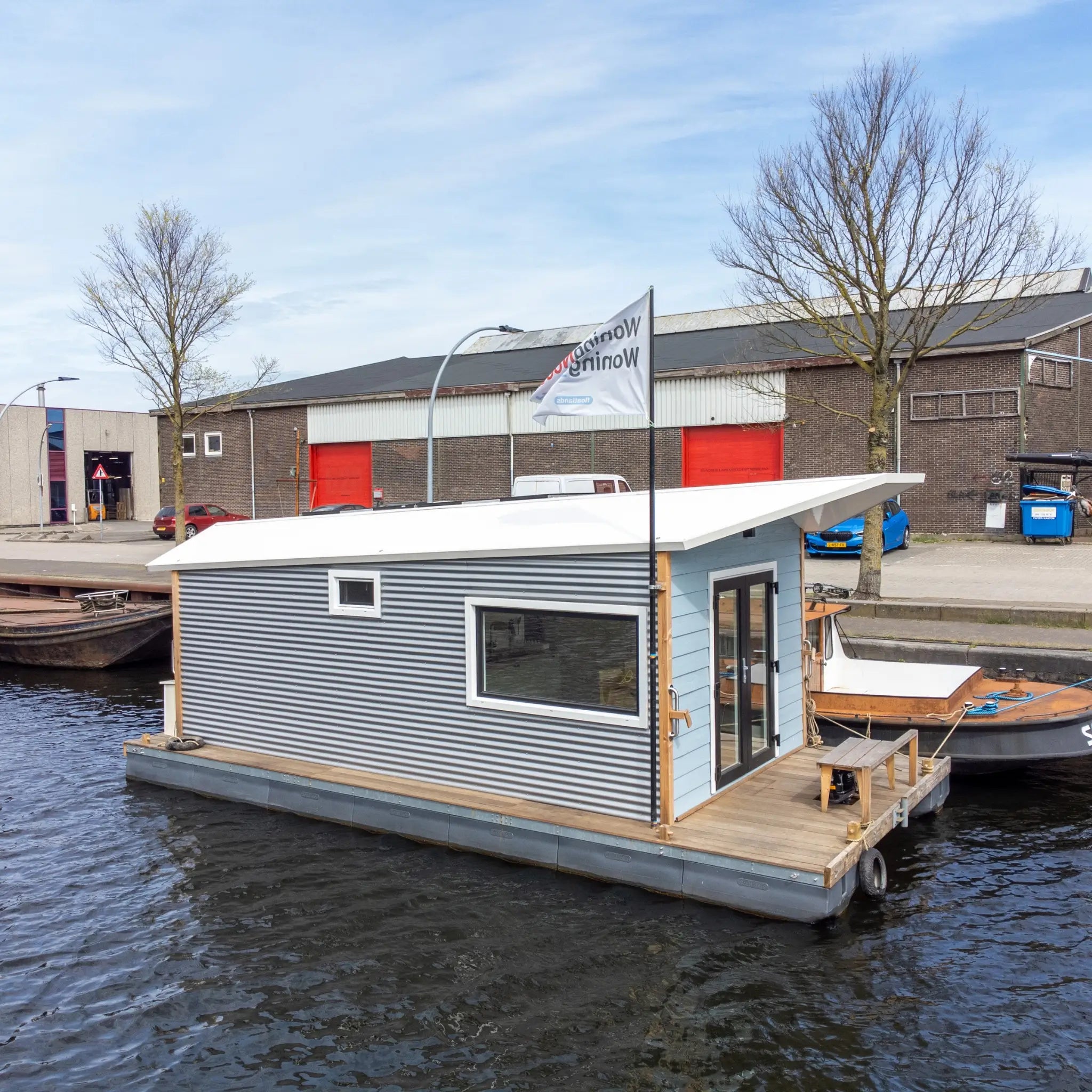 Side profile of a floating shepherd’s hut showcasing corrugated cladding and modern floating tiny home design.