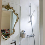 Bathroom interior of a floating shepherd’s hut featuring shower, vintage mirror and modern fittings.