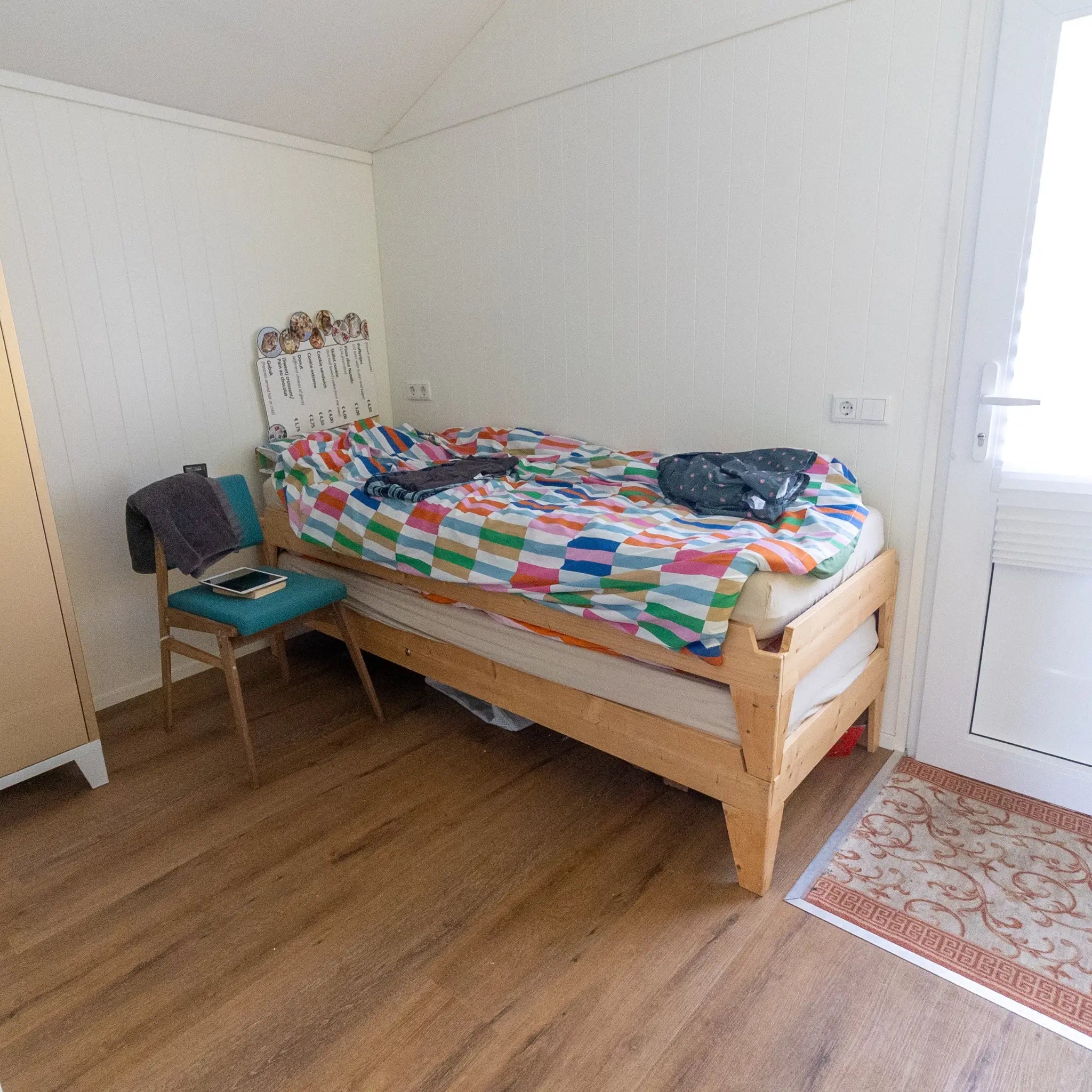 Bedroom interior of a floating shepherd’s hut with stacked single beds.