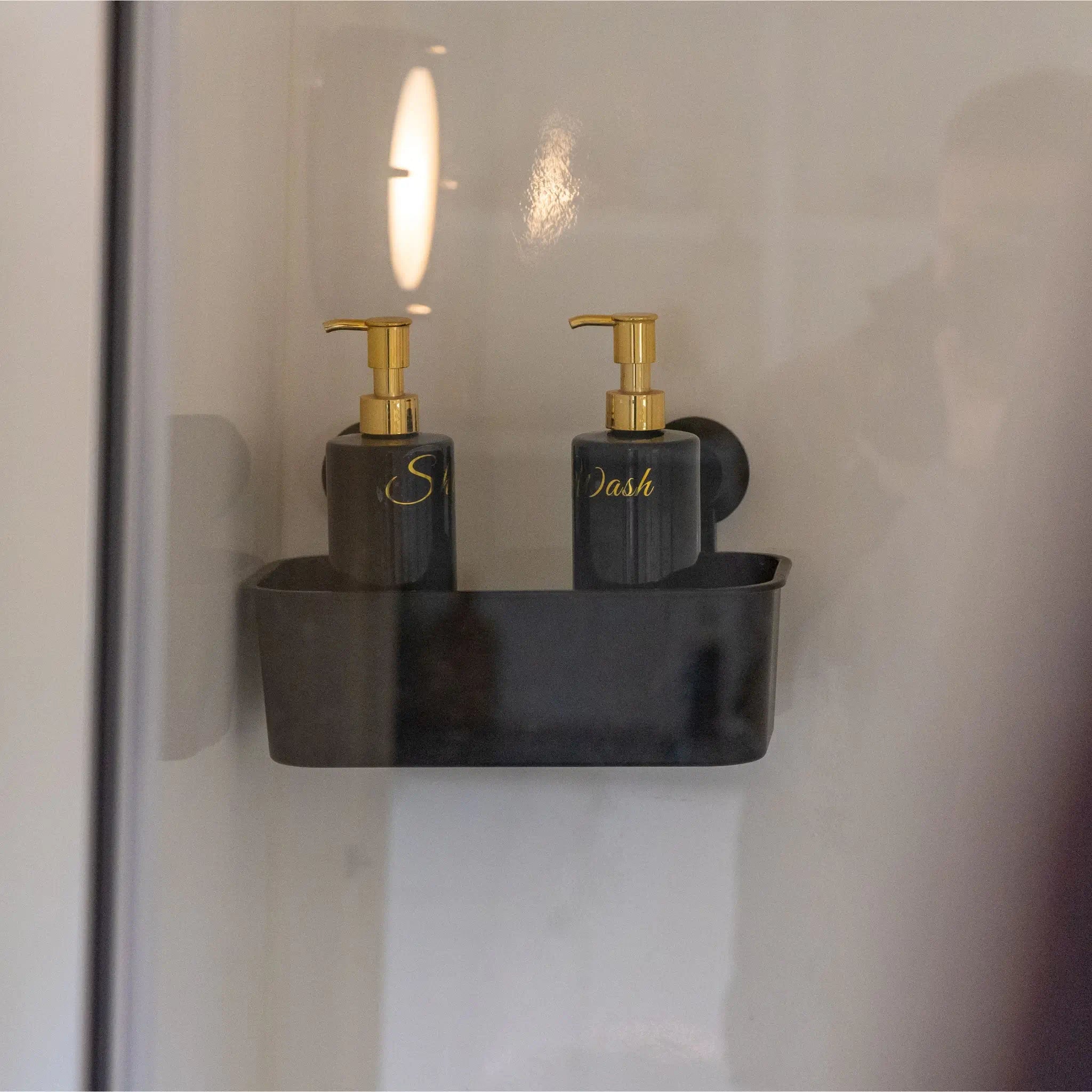 Bathroom shelf detail with matte black storage tray and elegant refillable dispensers.