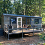Bowridge 2 person shepherd’s hut exterior with raised timber deck in woodland setting