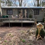 Front view of Bowridge shepherd’s hut glamping accommodation with outdoor deck