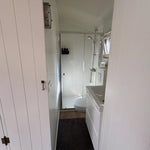 Interior hallway leading to bathroom inside Bowridge shepherd’s hut