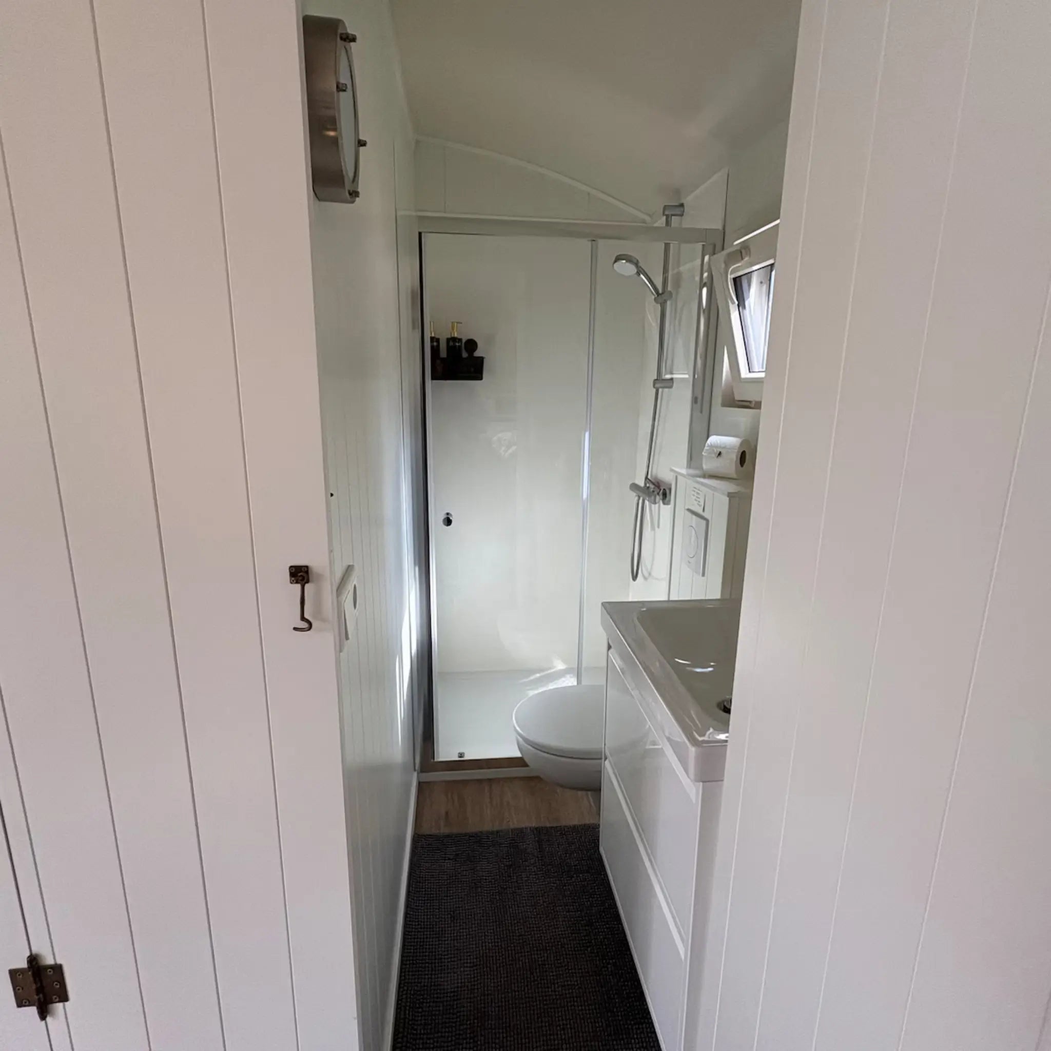 Interior hallway leading to bathroom inside Bowridge shepherd’s hut