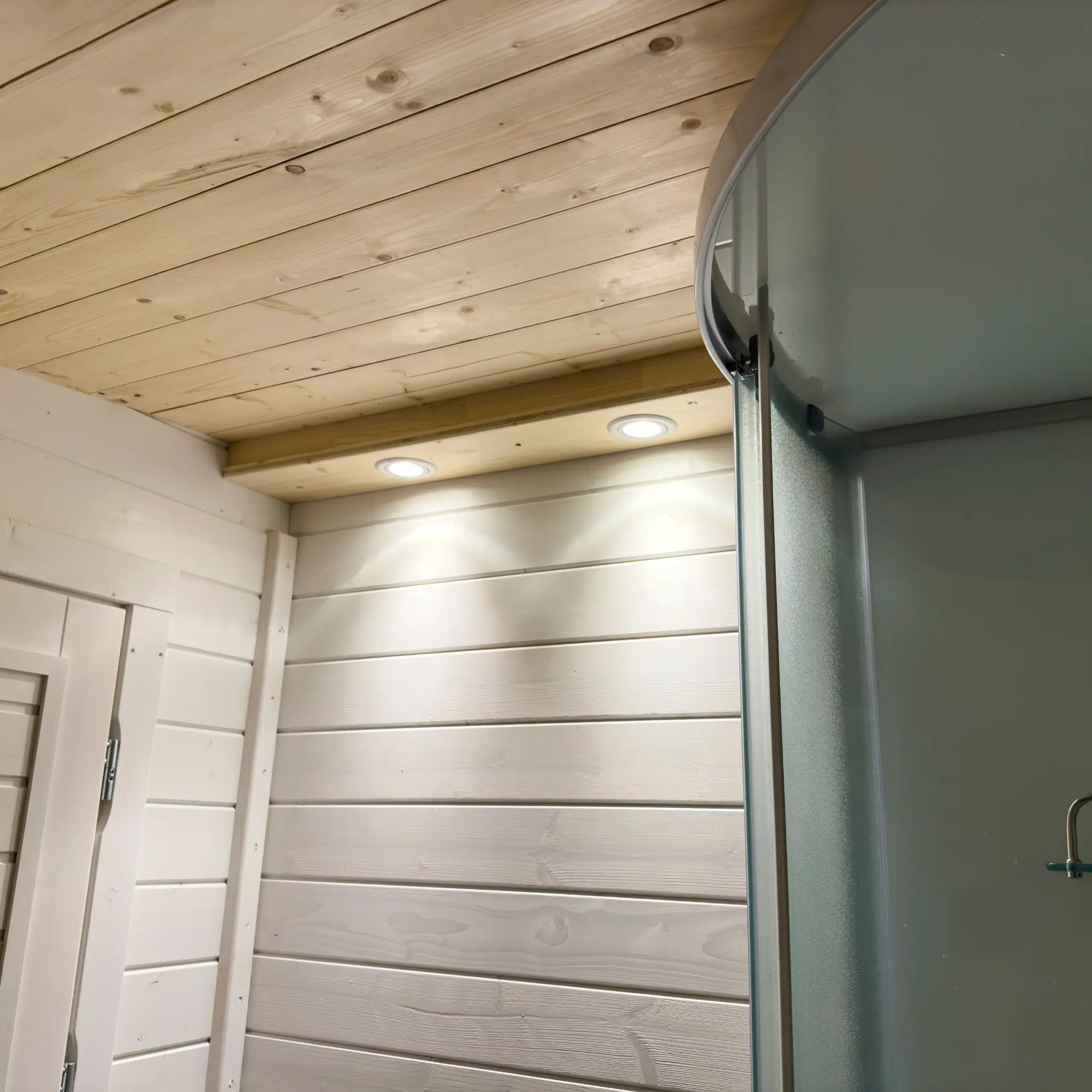 Recessed ceiling lights inside the bathroom of the Dual Halfmoon Pod with timber-lined curved ceiling