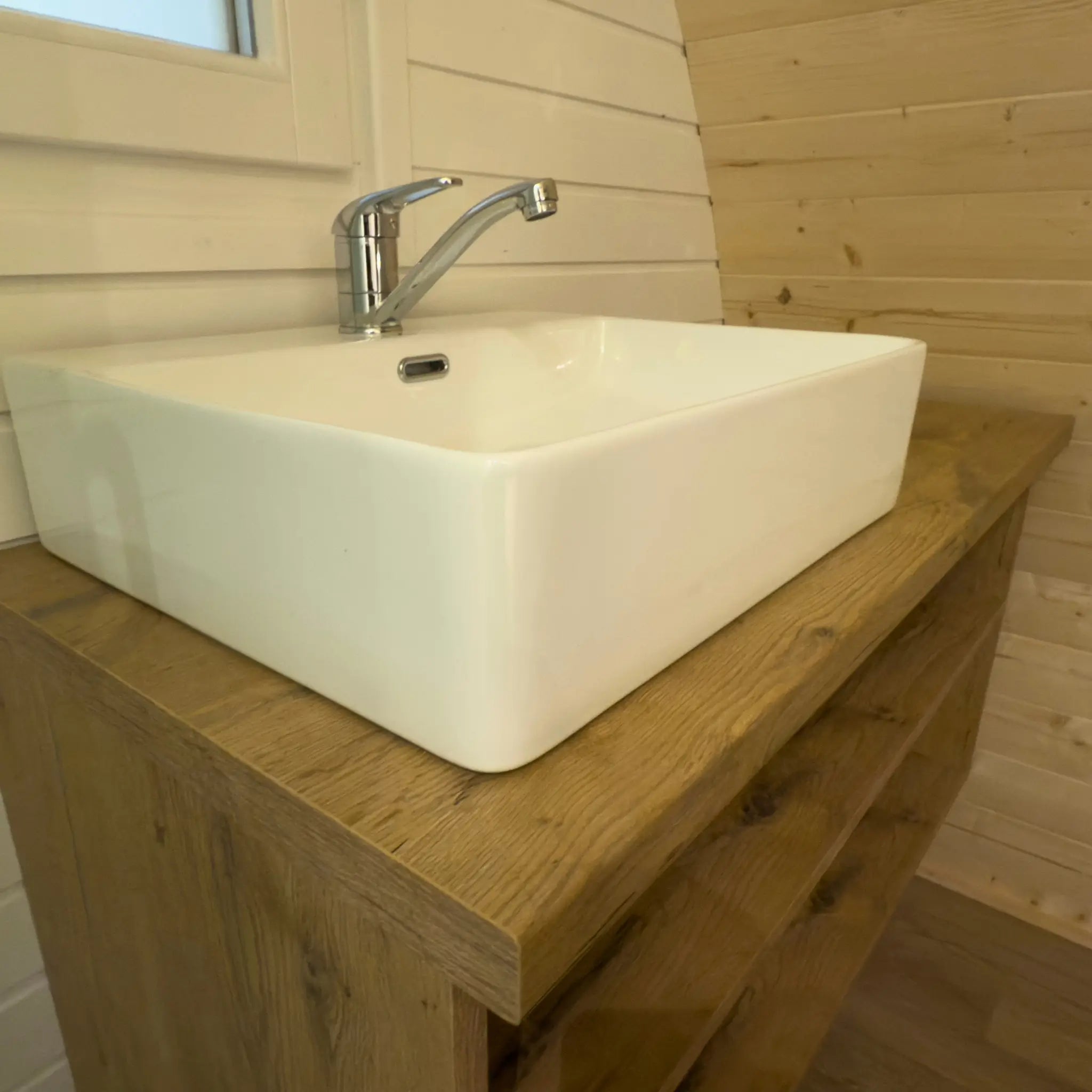 Contemporary ceramic basin on wooden vanity inside the Dual Halfmoon luxury glamping pod bathroom