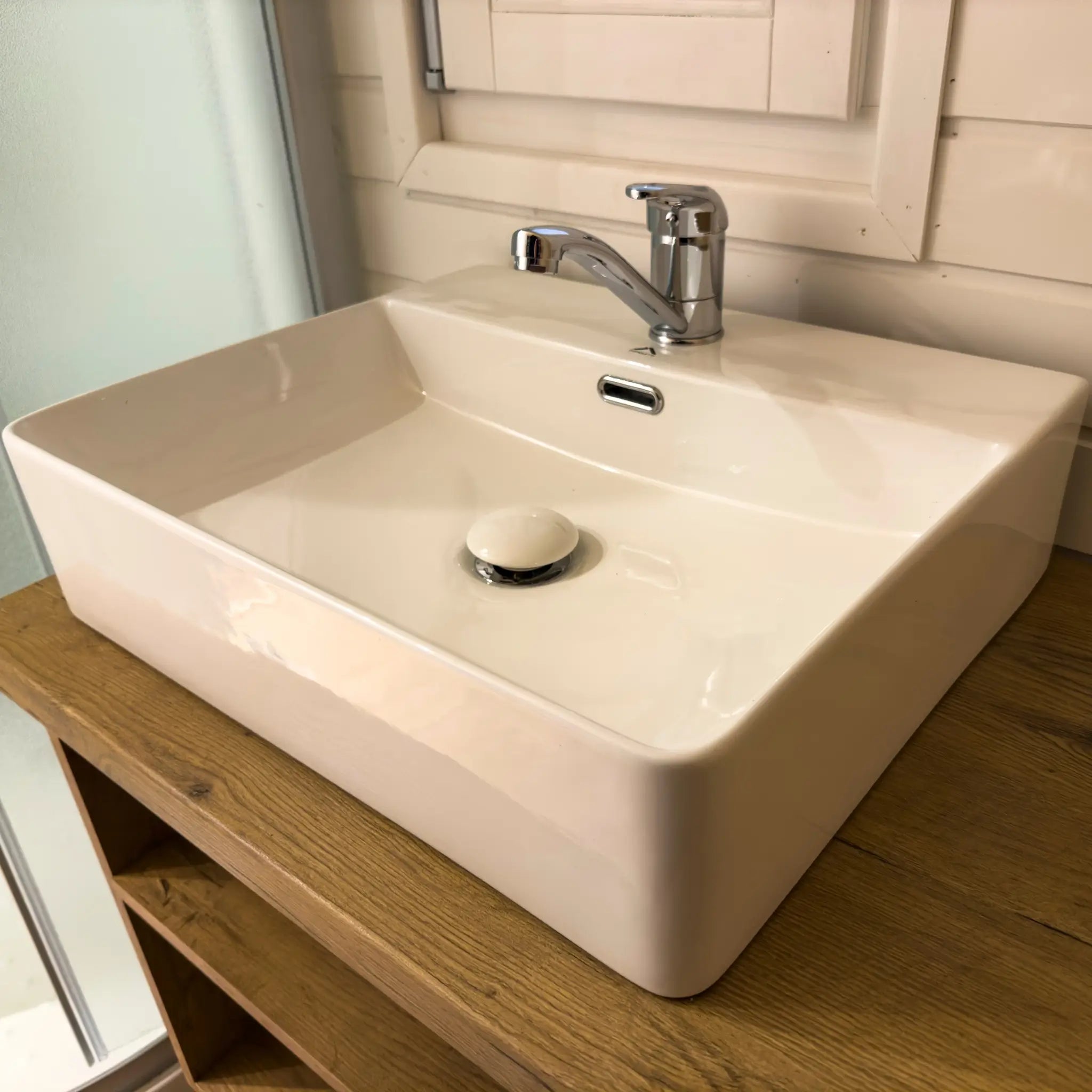 Modern bathroom sink and chrome tap inside the Dual Halfmoon Pod with timber vanity unit