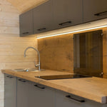 Close-up of the kitchen sink and wooden worktop inside the Dual Halfmoon glamping pod