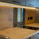 Detail of glass splash guard and electrical outlets above the kitchen counter