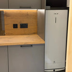 Kitchen corner inside the glamping pod showing wood countertop, cabinetry and integrated hot water heater
