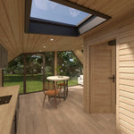 Open-plan kitchen and living area inside The Eagle's Nest luxury 2 person glamping pod with rooflight and panoramic glazing