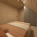 Bedroom interior of The Eagle's Nest luxury 2 person glamping pod featuring fitted wardrobe and warm timber finishes