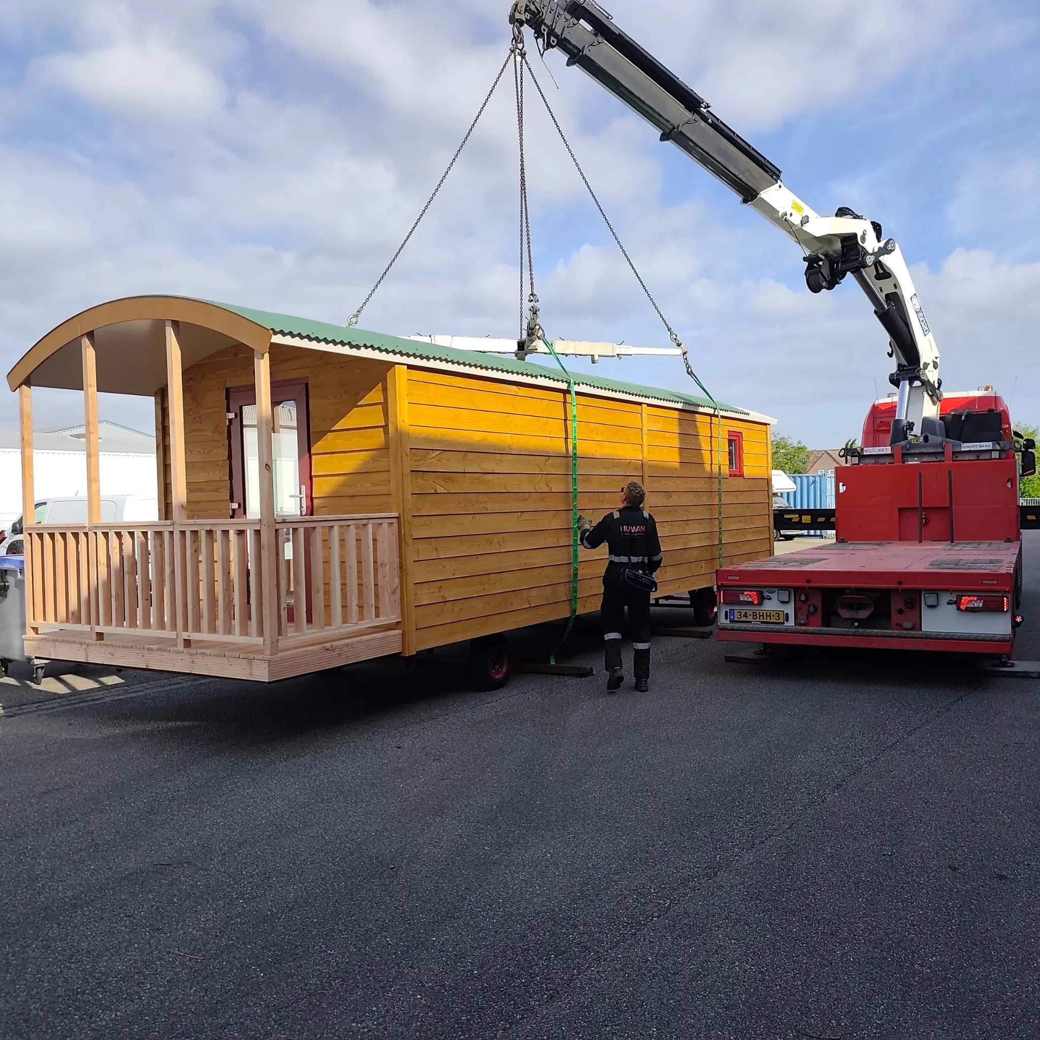 The “Fernwood” timber Art Studio being lifted by crane during transport and installation