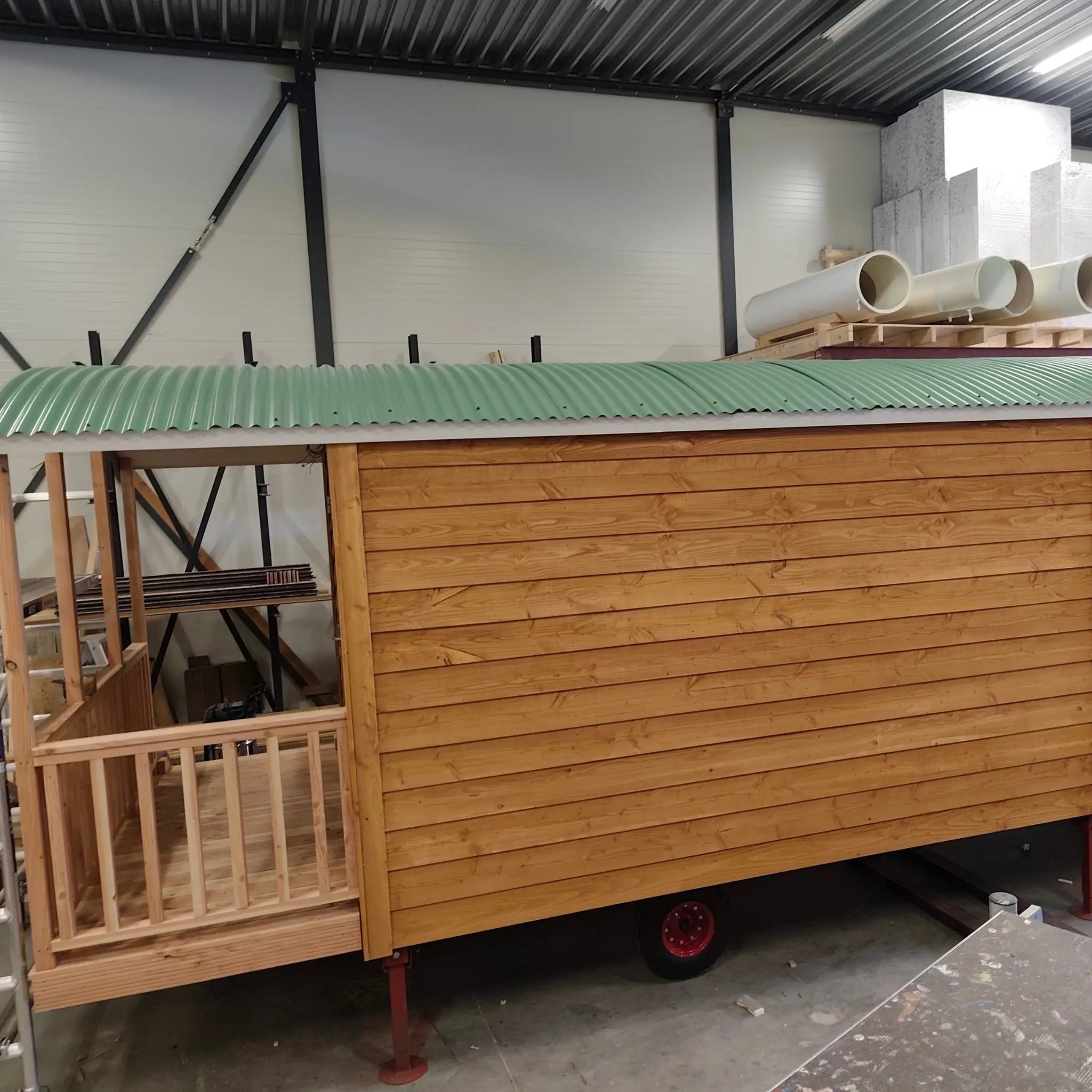 Side exterior view of The “Fernwood” Art Studio during construction with timber cladding and curved roof