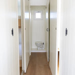 Interior hallway with sliding doors, wood-effect flooring, and compact WC access in modern floating shepherd’s hut.