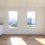 Open-plan living area with large windows, natural light, and spacious modern floating shepherd’s hut interior.
