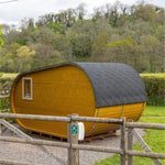 Rear view of Grotto glamping pod highlighting curved roof design and timber cladding