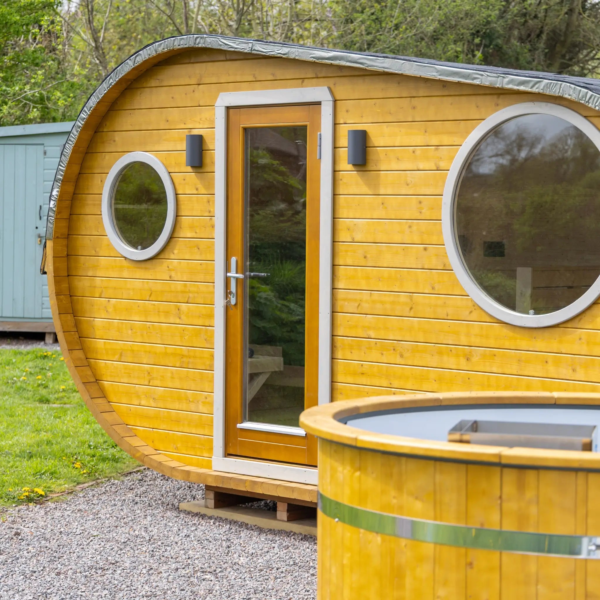 Side view of Grotto 3 berth glamping pod with rounded shape and compact footprint