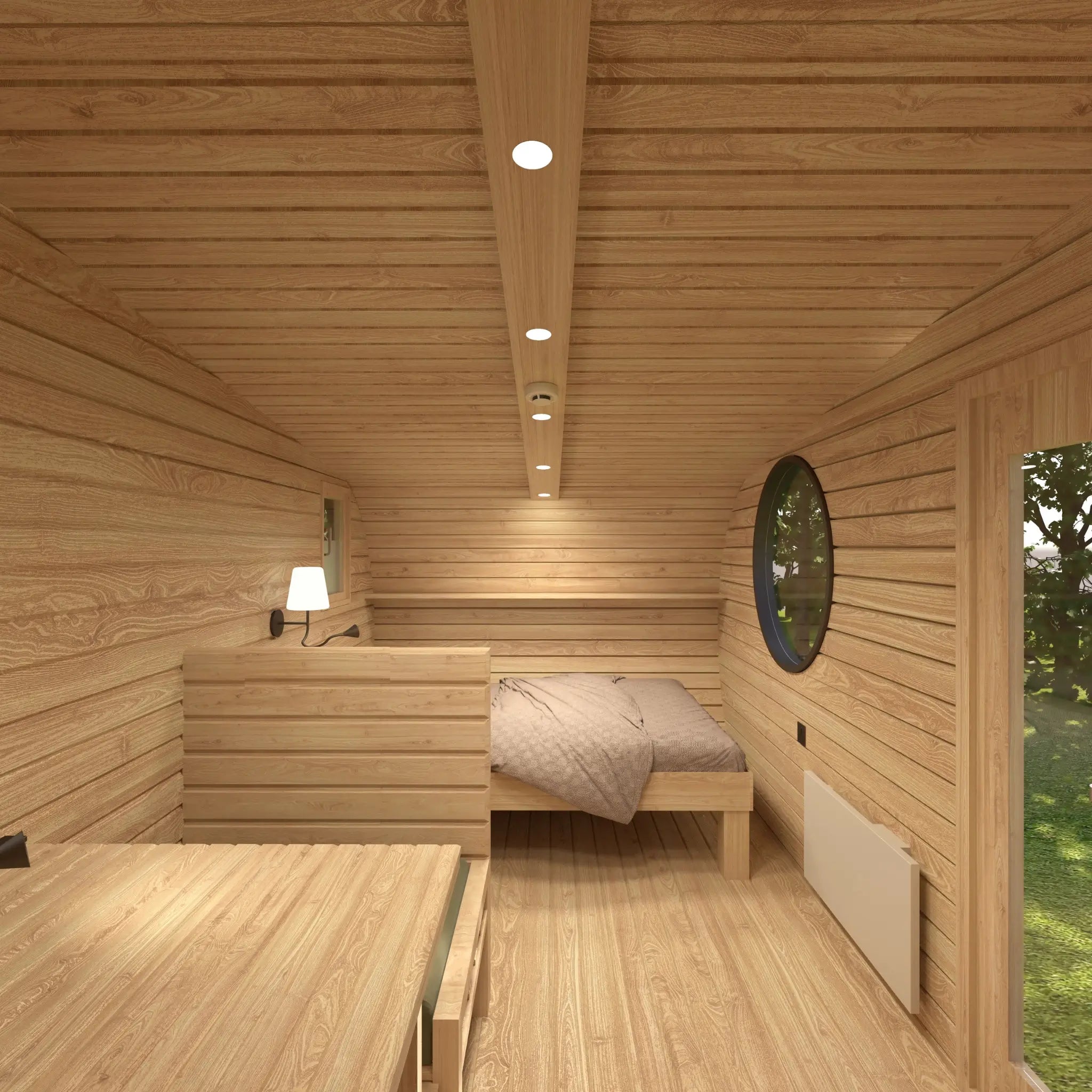 Open-plan interior layout of The Grotto Pod showing sleeping area and convertible living space.