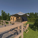 Side exterior view of The Grotto Pod with outdoor seating area and parasol.