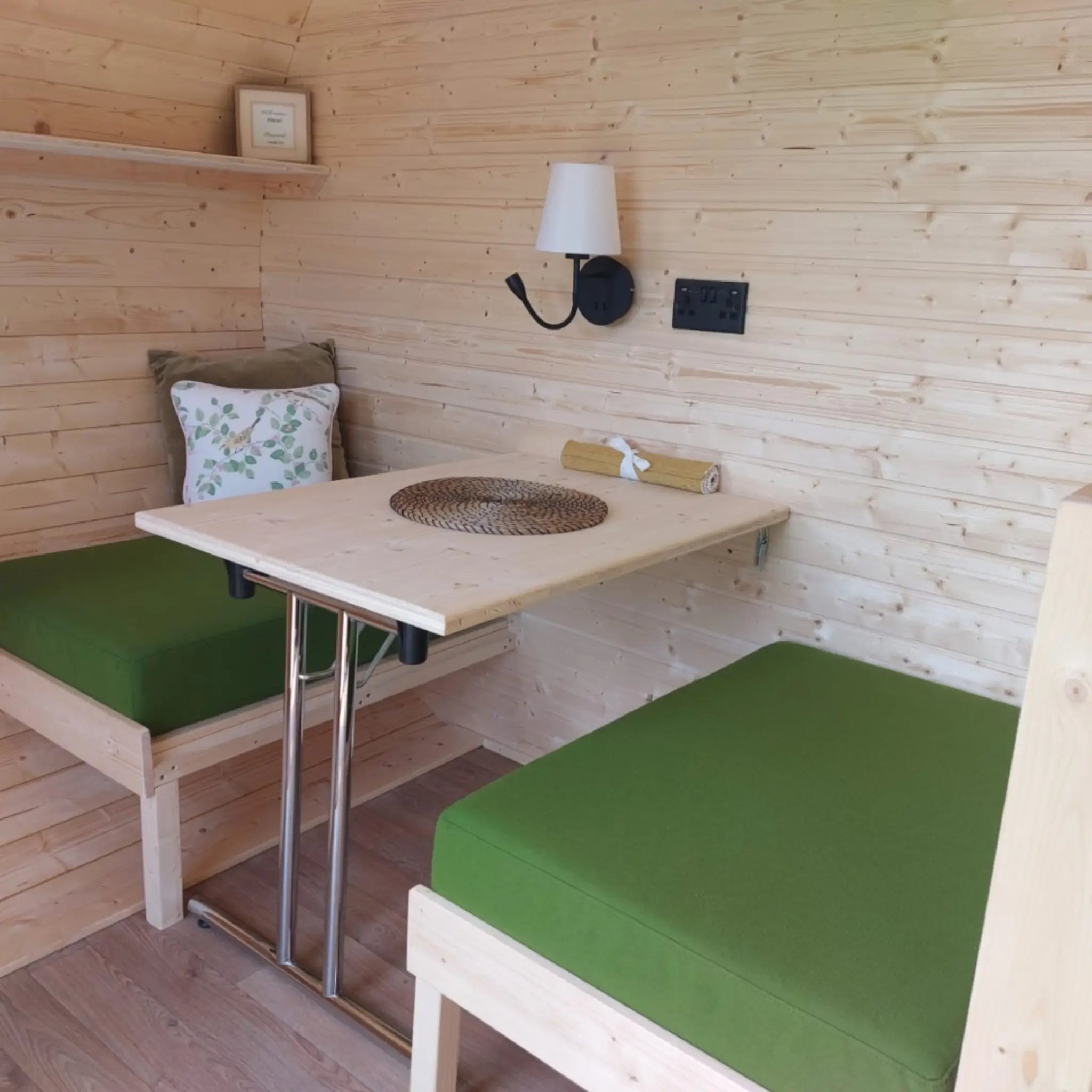 Convertible seating and dining table inside a luxury 3 person glamping pod