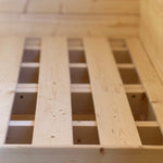 Close-up of solid wooden double bed frame base inside Grotto 3 berth glamping pod