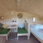 Opening timber framed side window inside a luxury 3 person glamping pod bedroom