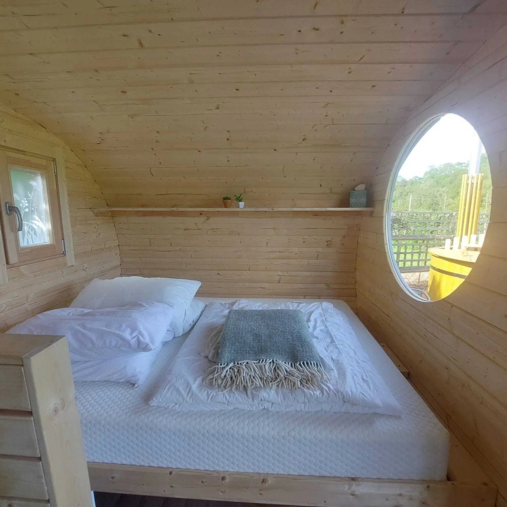 Comfortable double bed with premium glamping mattress inside a luxury glamping pod
