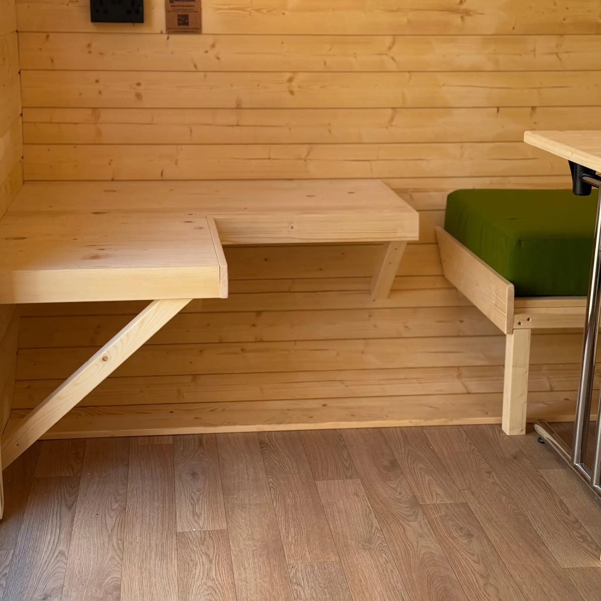 L shaped wall-mounted bench in Grotto glamping pod interior