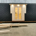 Full front exterior view of the Hearthwood Pod 5 Person Glamping Pod with disabled access, featuring double doors and curved shingle roof