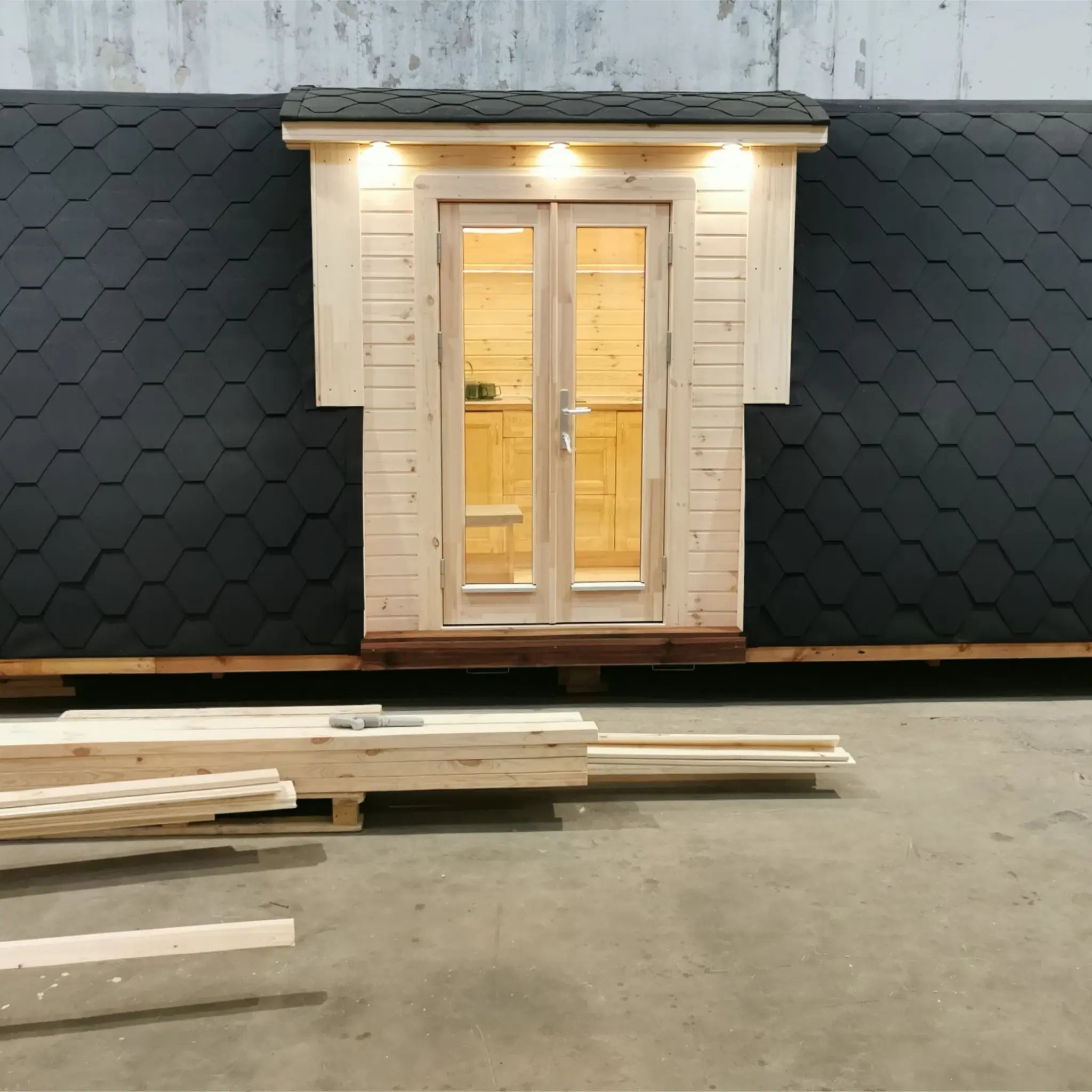 Full front exterior view of the Hearthwood Pod 5 Person Glamping Pod with disabled access, featuring double doors and curved shingle roof