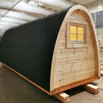 Left-side exterior view of the Hearthwood Pod 5 Person Glamping Pod with disabled access, showing timber cladding and rear window
