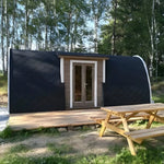 Hearthwood glamping pod set in a woodland garden with timber deck and picnic table at the front