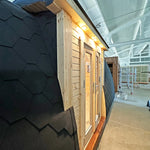 Close-up of the Hearthwood pod’s curved roof and timber wall detailing