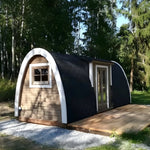 Side exterior view of the Hearthwood luxury 2–4 person glamping pod in a landscaped outdoor setting