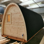 Rear angle view of The Hearthwood Pod luxury glamping pod showing rounded wooden structure and insulated roofing