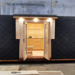 Detailed front view of The Hearthwood Pod luxury 2 person glamping pod with illuminated entrance and curved roof design