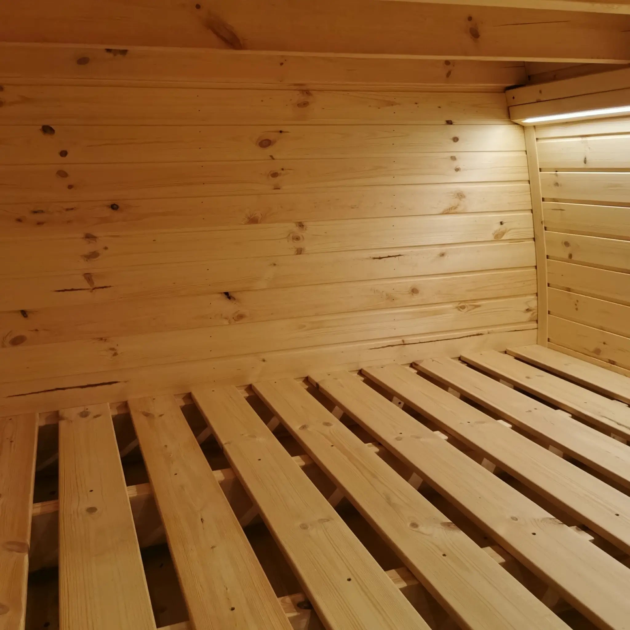 Interior sleeping area of The Hearthwood Pod luxury 2 person glamping pod showing wooden bunk bed structure